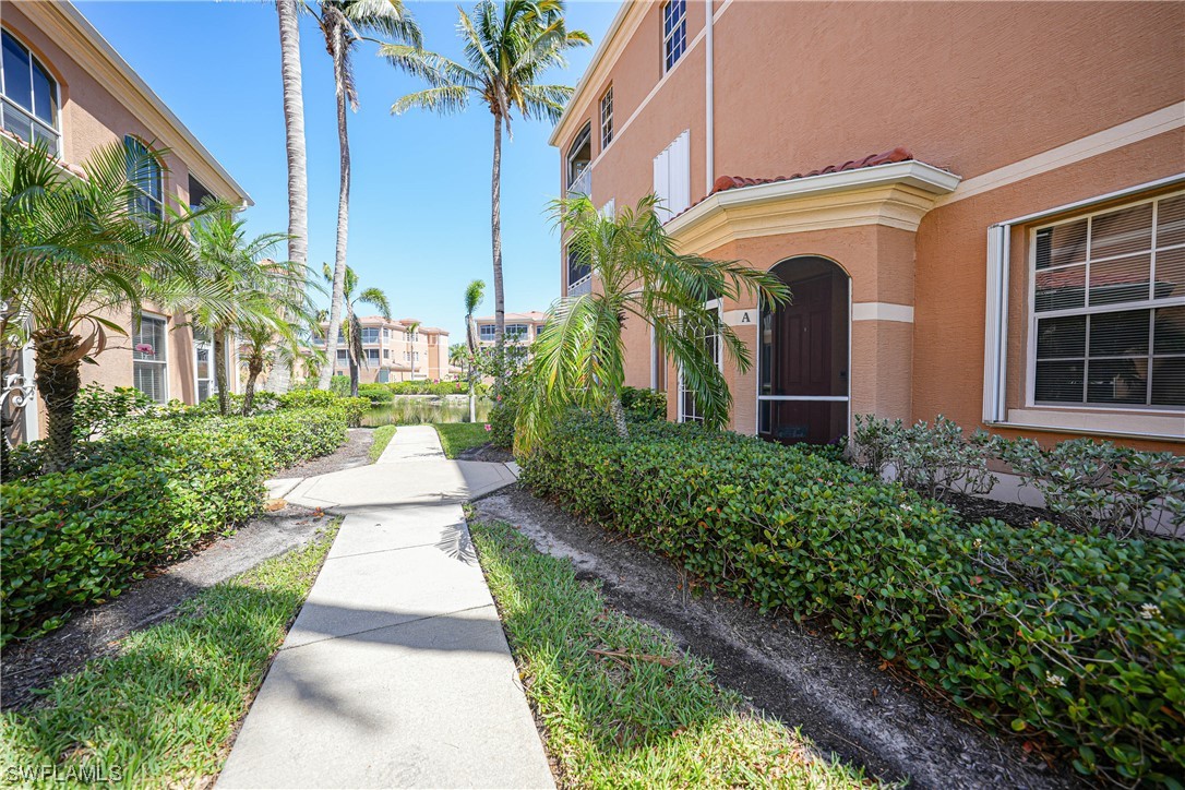 3228 Sunset Key Circle, Unit 101 Punta Gorda, FL 33955 - Photo 2 of 33 a front view of a house with a yard and potted plants