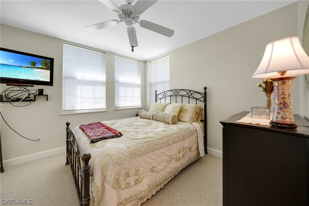 3228 Sunset Key Circle, Unit 101 Punta Gorda, FL 33955 - Photo 22 of 33 a bedroom with a bed and a lamp