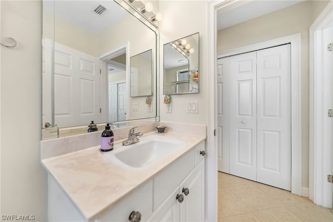 3228 Sunset Key Circle, Unit 101 Punta Gorda, FL 33955 - Photo 25 of 33 a bathroom with a sink and a mirror