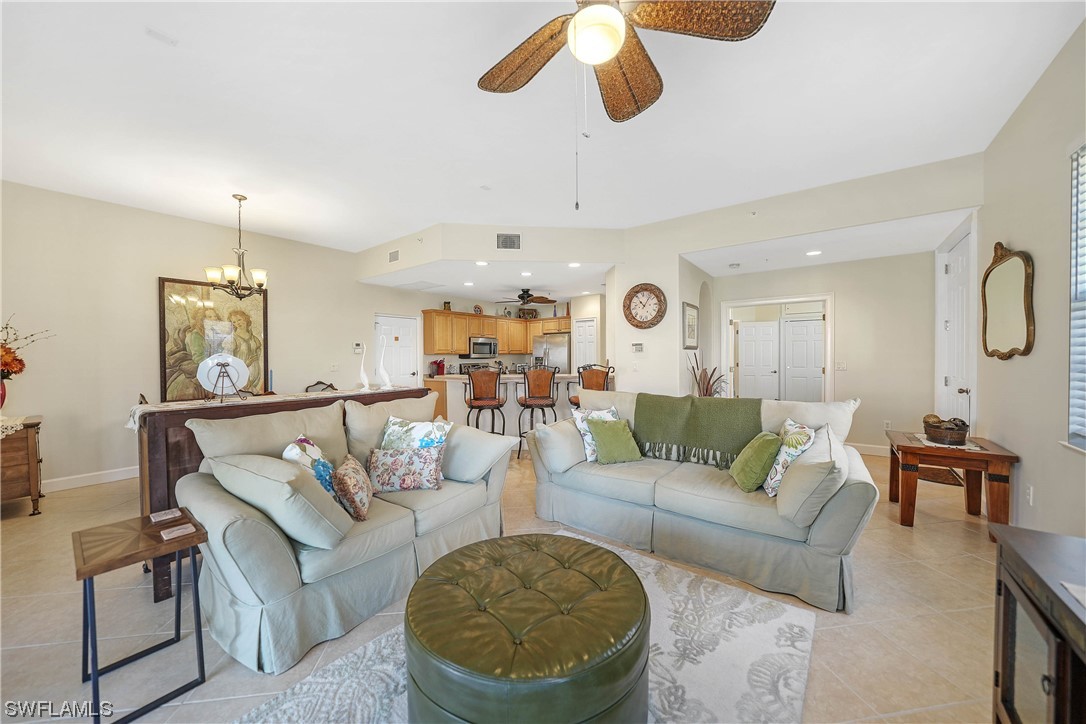3228 Sunset Key Circle, Unit 101 Punta Gorda, FL 33955 - Photo 9 of 33 a living room with furniture kitchen view and a chandelier