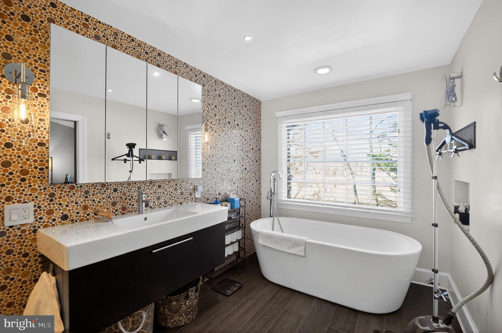 128 Rees Place Falls Church, VA 22046 - Photo 31 of 47 a bathroom with a bathtub a sink and a window