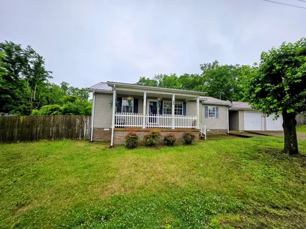 a view of a house with backyard sitting area and garden