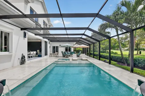 an aerial view of a house with a swimming pool yard and outdoor seating