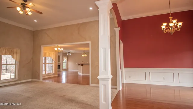 a view of a livingroom with a ceiling fan and window