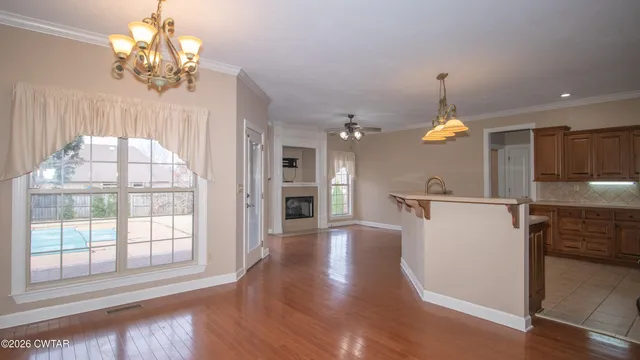 a view of a kitchen with a sink and dishwasher a wooden floor
