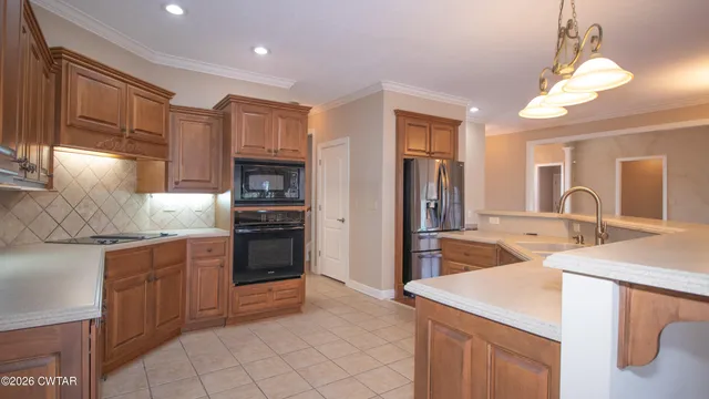 a kitchen with stainless steel appliances granite countertop a sink and cabinets