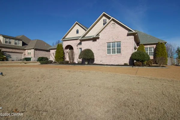 a front view of a house with a yard