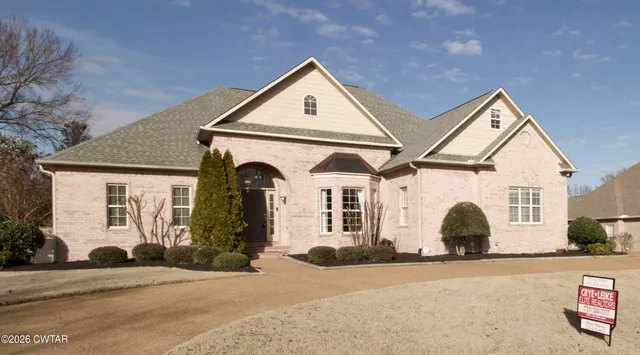 a view of a white house with a street