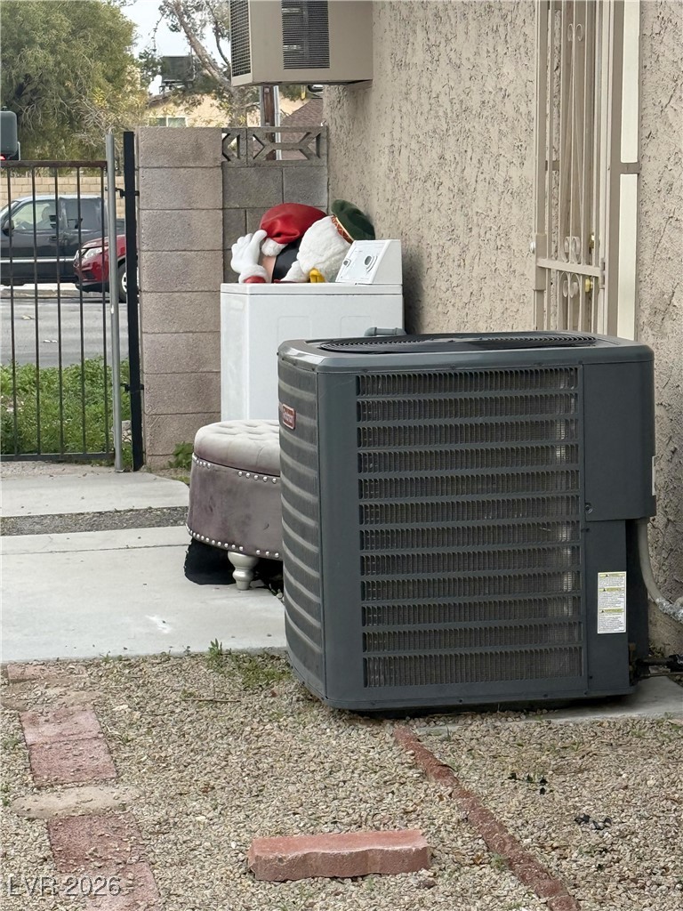 5311 South Sandhill Road Las Vegas, NV 89120 - Photo 24 of 24 Exterior view of washer / clothes dryer, a gate, and stucco siding