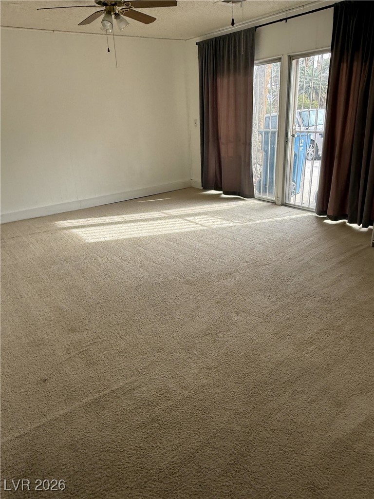 5311 South Sandhill Road Las Vegas, NV 89120 - Photo 3 of 24 Spare room featuring carpet flooring, a ceiling fan, and a textured ceiling