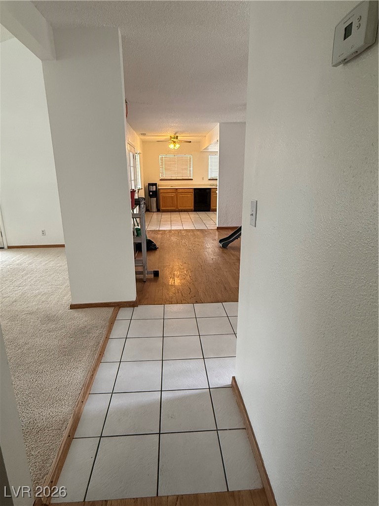 5311 South Sandhill Road Las Vegas, NV 89120 - Photo 6 of 24 Hall featuring light tile patterned floors, light carpet, a textured ceiling, and a textured wall