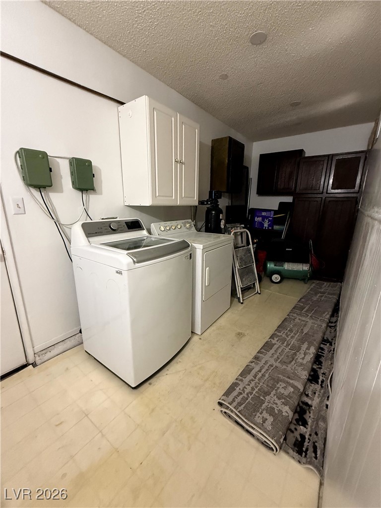 5311 South Sandhill Road Las Vegas, NV 89120 - Photo 8 of 24 Washroom featuring light floors, cabinet space, independent washer and dryer, and a textured ceiling