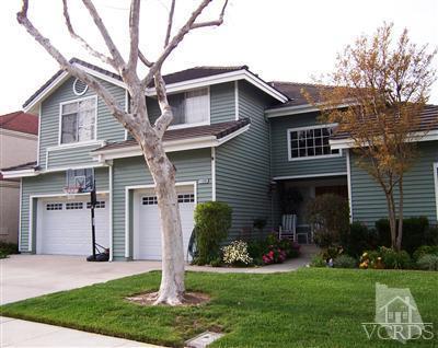 11699 Chestnut Ridge Street Moorpark, CA 93021 - Photo 2 of 20 a front view of a house with a yard and garage