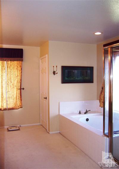 11699 Chestnut Ridge Street Moorpark, CA 93021 - Photo 14 of 20 a bathroom with a bathtub and a shower