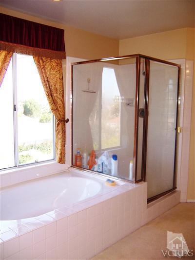 11699 Chestnut Ridge Street Moorpark, CA 93021 - Photo 15 of 20 a bed room with a bed and a mirror