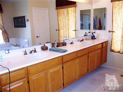 11699 Chestnut Ridge Street Moorpark, CA 93021 - Photo 16 of 20 a bathroom with a double vanity sink and a mirror