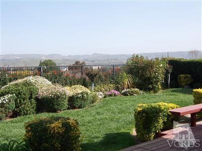 11699 Chestnut Ridge Street Moorpark, CA 93021 - Photo 17 of 20 a view of a garden with a building in the background