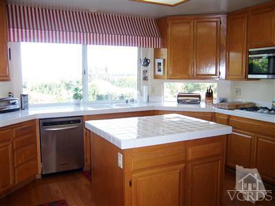 11699 Chestnut Ridge Street Moorpark, CA 93021 - Photo 8 of 20 a kitchen with a sink stove and cabinets