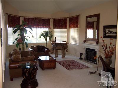 11699 Chestnut Ridge Street Moorpark, CA 93021 - Photo 10 of 20 a living room with furniture a fireplace and a flat screen tv