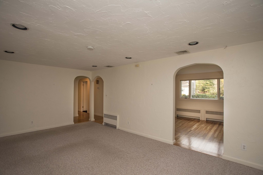 6 Marcus Road Sharon, MA 02067 - Photo 5 of 24 an empty room with a fireplace and windows