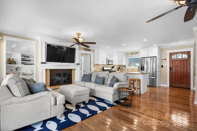 a kitchen with stainless steel appliances granite countertop a refrigerator stove top oven and sink