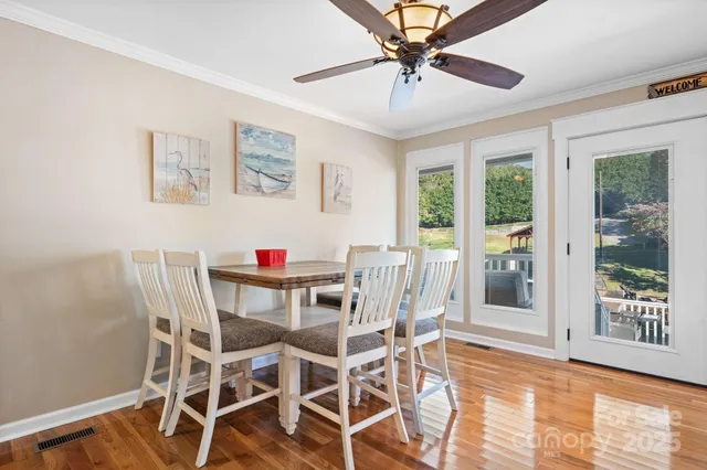 a kitchen with stove a sink and chairs