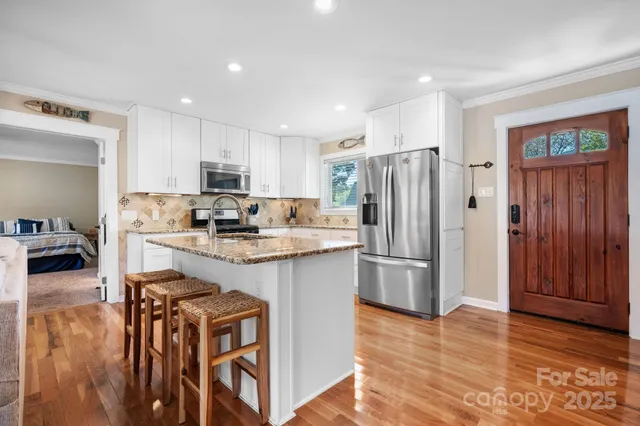 a kitchen with granite countertop cabinets a counter space and stainless steel appliances