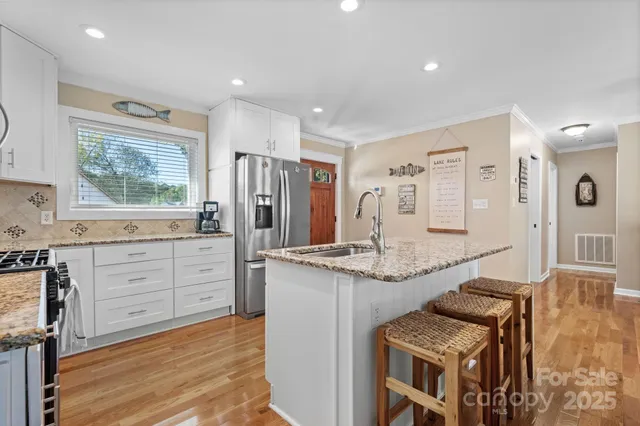 a bathroom with a granite countertop toilet a sink and mirror