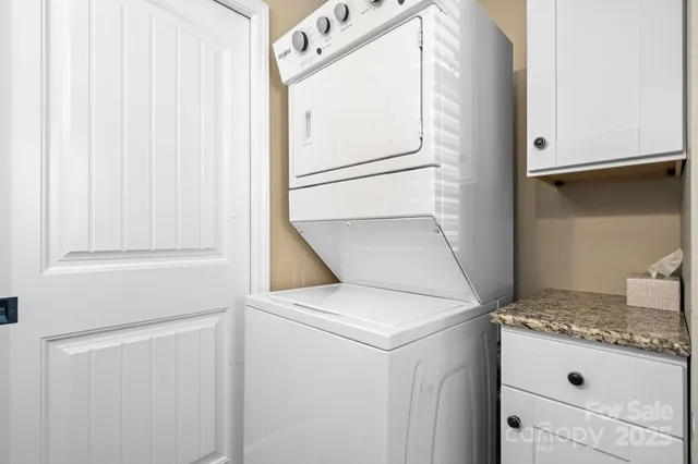 a view of house with river and trees in the background