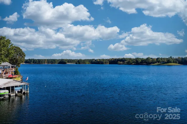 a view of a house with a deck and a yard
