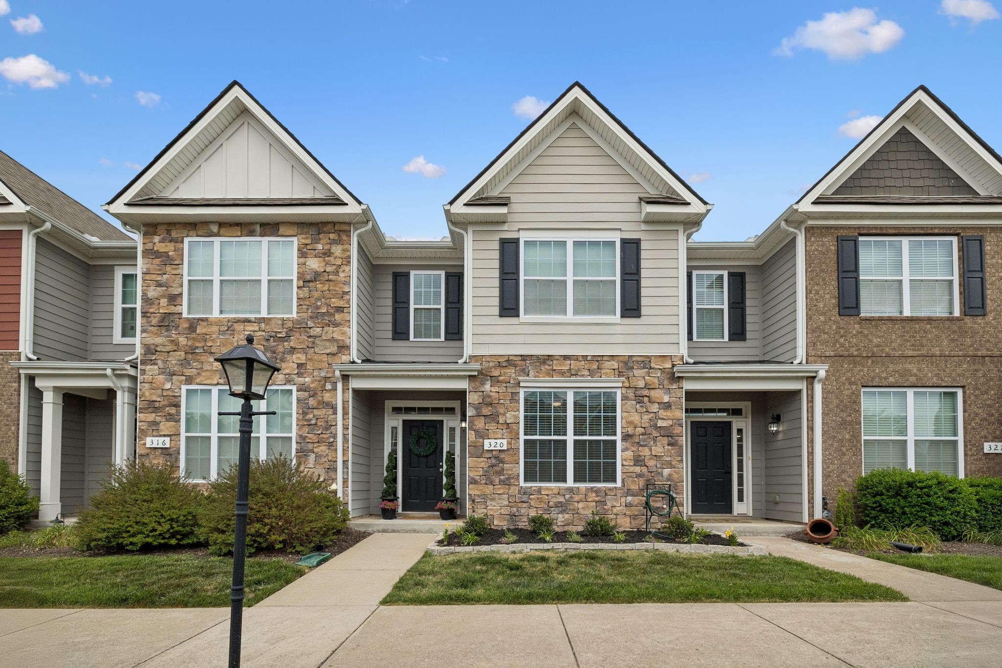 320 Manor Row Pleasant View, TN 37146 - Photo 1 of 39 a front view of a house with garden