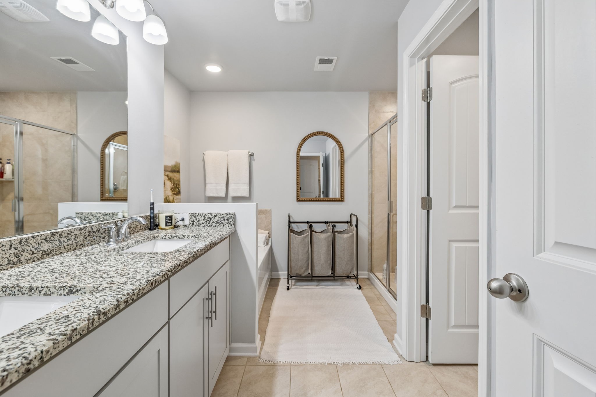 320 Manor Row Pleasant View, TN 37146 - Photo 30 of 39 a bathroom with a granite countertop sink a mirror and a shower
