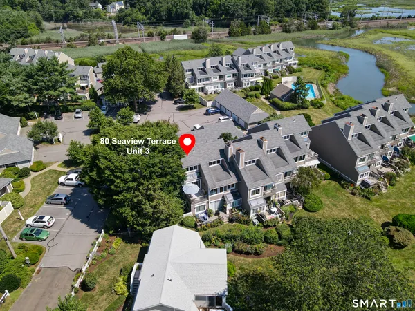 an aerial view of house with yard swimming pool and outdoor seating