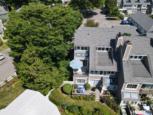 an aerial view of a house with garden space and street view