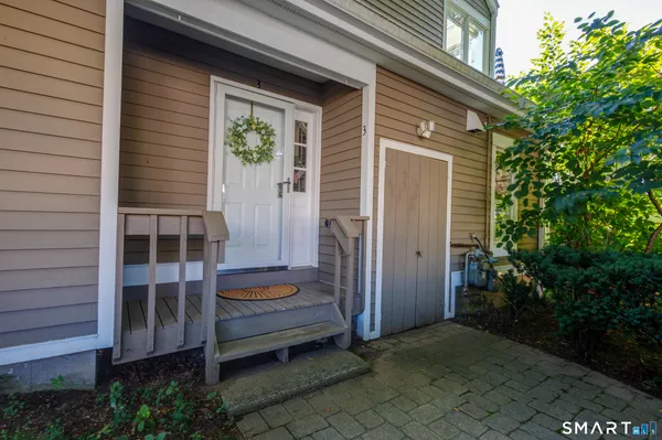a backyard of a house with dishwasher and wooden fence