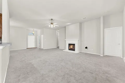 a view of a livingroom with a fireplace and a window
