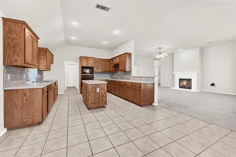 a large kitchen with stainless steel appliances lots of counter top space