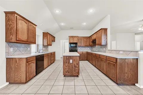 a large kitchen with stainless steel appliances granite countertop lots of counter top space