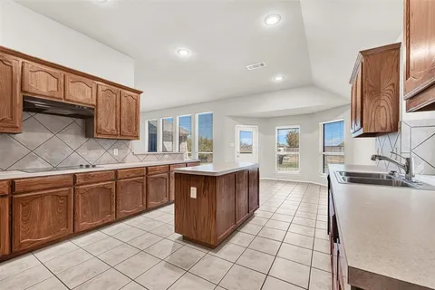 a kitchen with stainless steel appliances granite countertop a sink counter space and cabinets