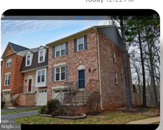 a view of a brick house with large windows and a yard