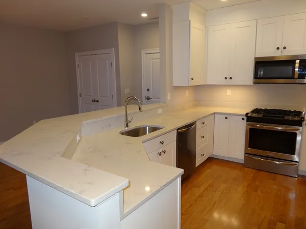 a kitchen with a sink a stove and cabinets