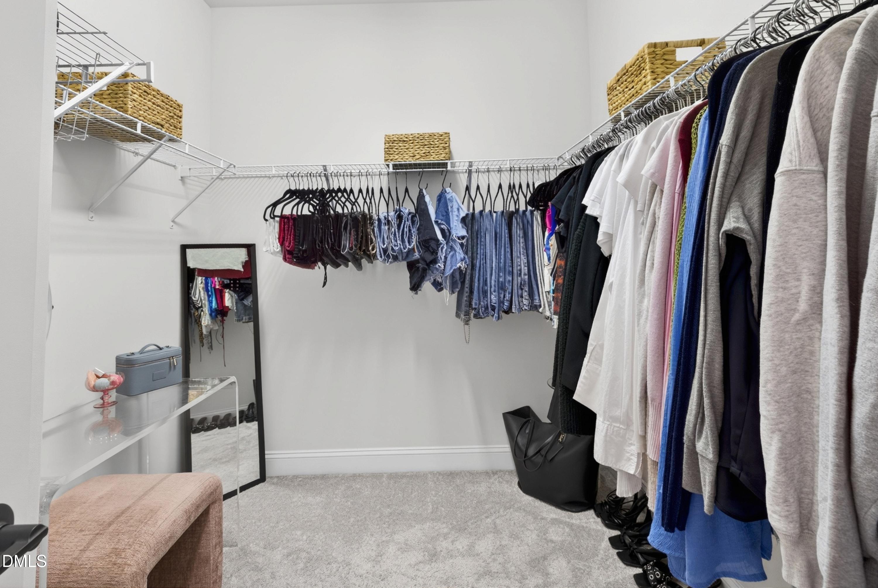1063 Danvers Loop Apex, NC 27523 - Photo 42 of 67 a view of walk in closet with clothes and shoes