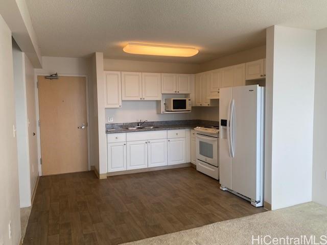 801 South Street, Unit 4507 Honolulu, HI 96813 - Photo 2 of 11 a kitchen with white cabinets and white appliances