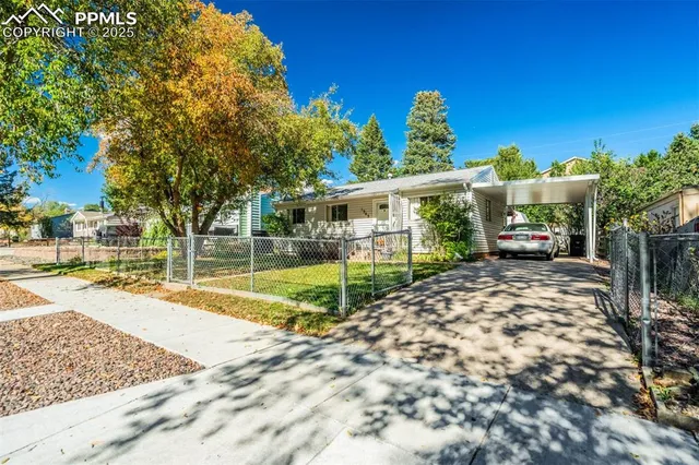 a view of a house with backyard and sitting area