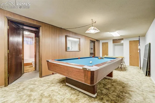 a room with pool table and windows