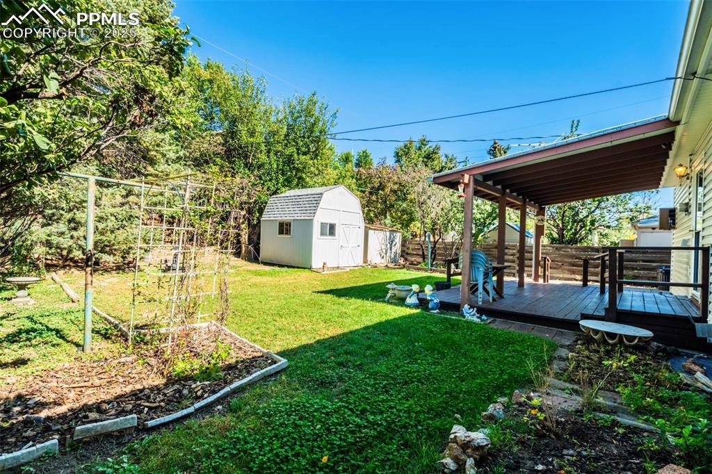 1343 Oswego Street Colorado Springs, CO 80904 - Photo 39 of 47 a view of a backyard with table and chairs under an umbrella