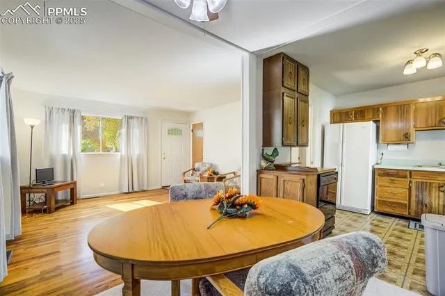 a kitchen with a refrigerator a stove top oven a sink and cabinets