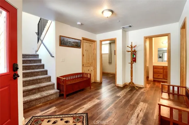 a living room with furniture a large window and a table