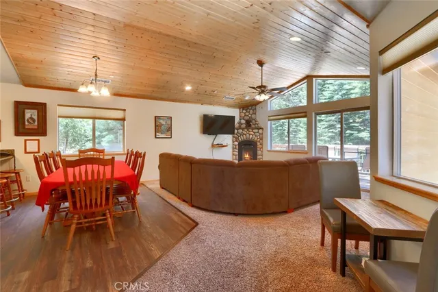 a kitchen with stainless steel appliances granite countertop wooden cabinets a sink and dishwasher with wooden floor