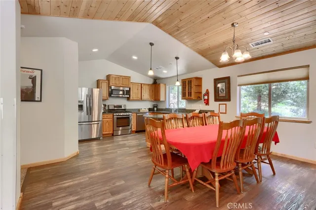a kitchen with stainless steel appliances granite countertop a refrigerator stove top oven and sink